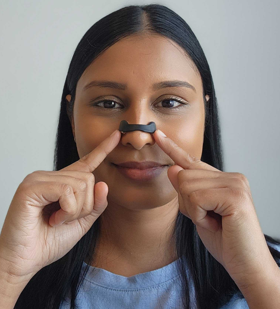 woman showing how to apply magnetic nasal strips