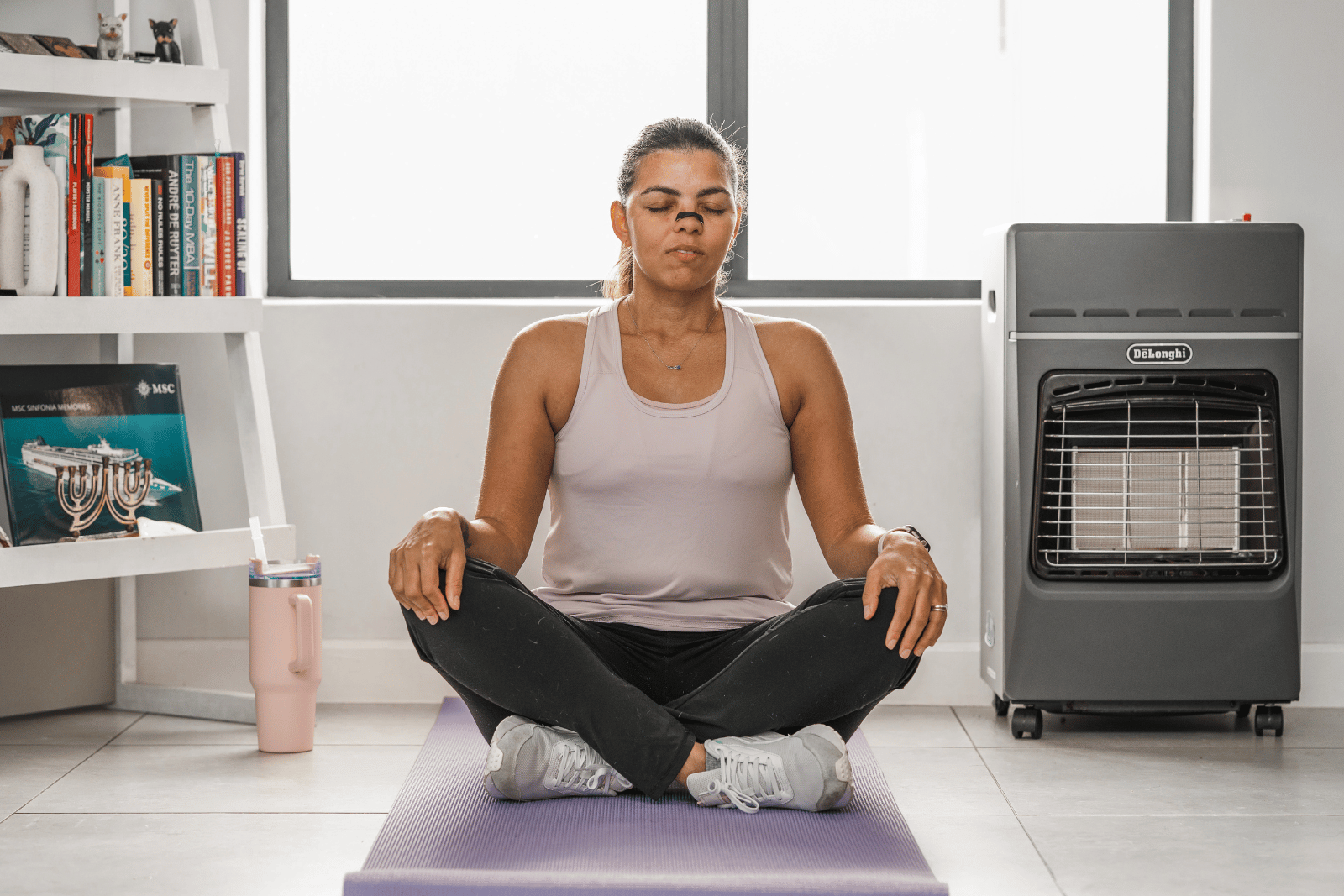 woman wearing nasal strips while doing yoga